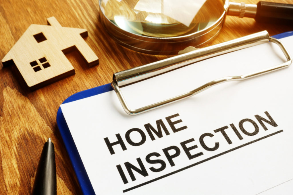 Home inspection checklist is shown on a clip board